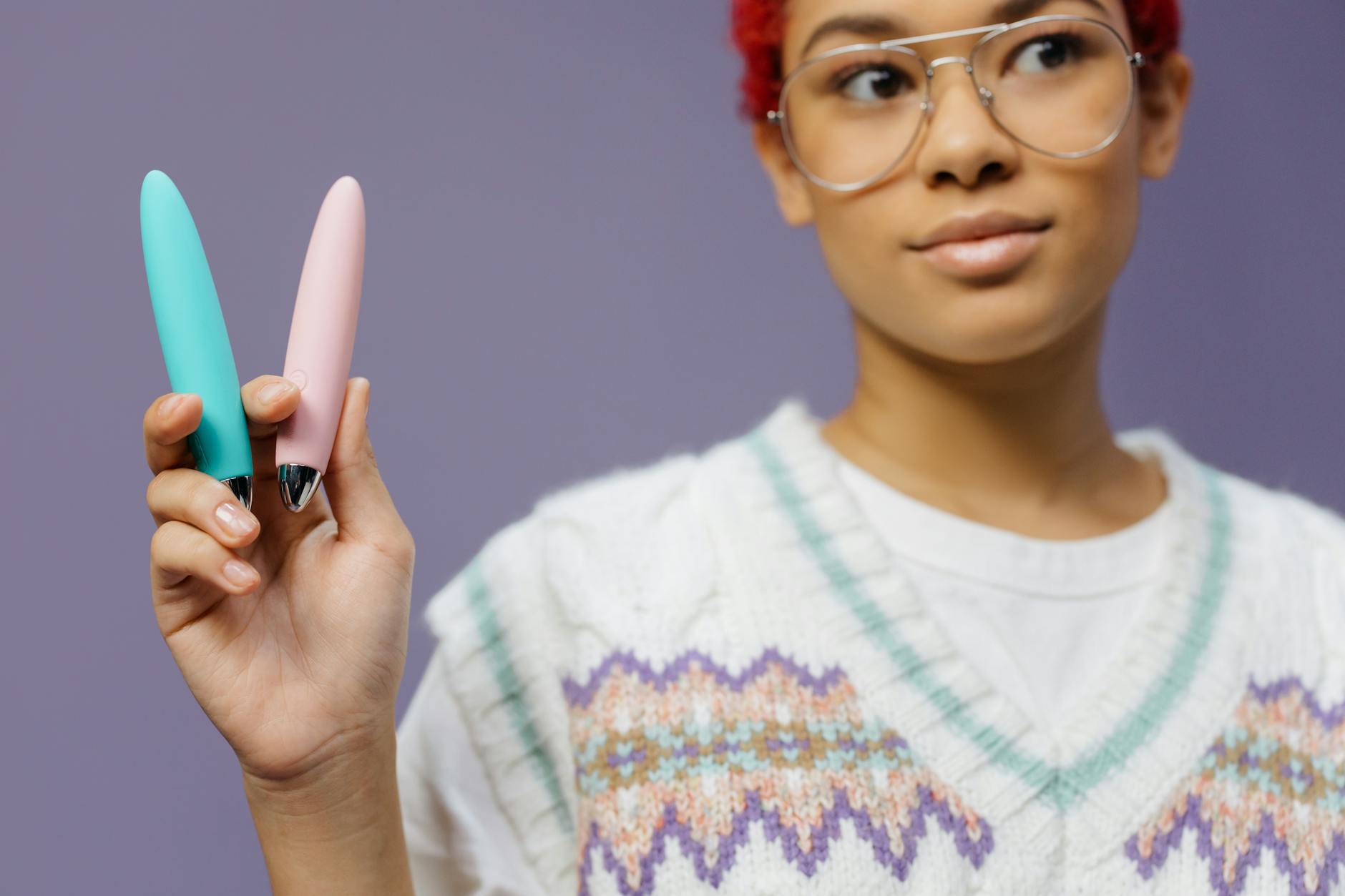 Woman holding vibrators while exploring intensity levels